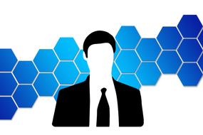 silhouettes of a businessman on a background of blue honeycombs