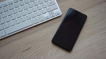 Smartphone and Keyboard on Desk