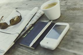 newspaper, glasses, Hot Drink and cell phone