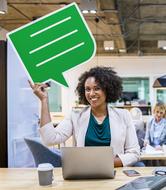 happy Afro American woman with green blank speech bubble