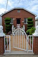 new one-storey House behind brick fence