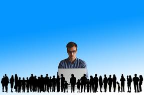entrepreneur, young man at laptop behind human silhouettes in row