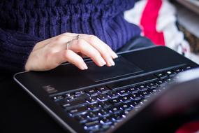 busy woman typing at laptop