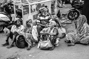group of tribal People sits on street in City