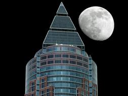 model of a skyscraper on a background of the moon