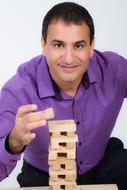 man stacks on a wooden pyramid