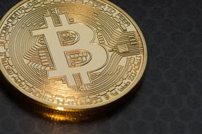 golden bitcoin on a black table
