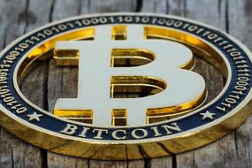 golden bitcoin on a wooden table