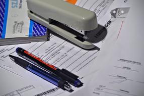 Stapler Pen Paperwork close up on the table