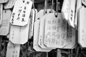 black and white photo of tags with hieroglyphs