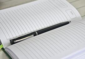 Pen in blank open Notebook