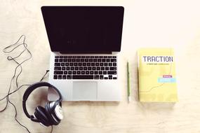 Macbook Laptop and yellow book