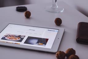 tablet and nuts on the table