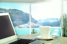 Apple Macbook on the desktop in a room with panoramic windows