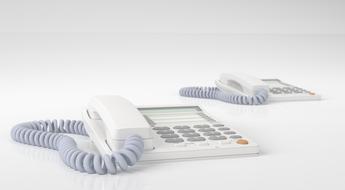 two white wired phones