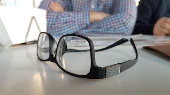 black glasses lie on the office desk
