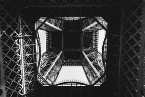 Black and white photo with the low angle shot of the beautiful Eiffel Tower in Paris, France