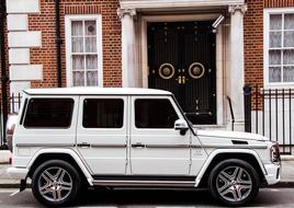 Luxury Car Vehicle parked near a brick house