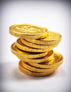 tower of gold coins on a white background