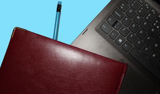 the leather folder lies on the laptop