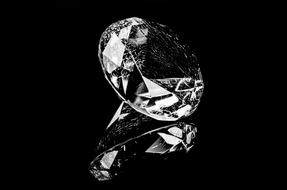 Black and white photo, with the close-up of the beautiful, shiny diamond, with the reflection, on the black surface, clipart