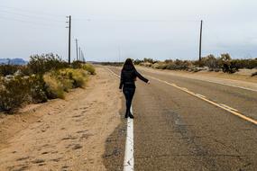 girl catches the car on the road in California