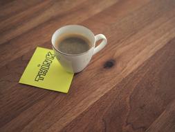 note under a cup of coffee