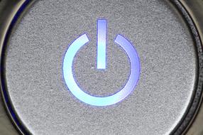 Shiny, blue and violet, gradient power button on the machine