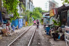 Beautiful landscape of the railroad, among the houses and green plants in Bangkok, Thailand