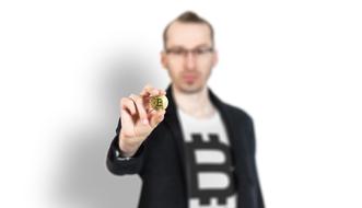 bitcoin in the hands of a young man in a blurred background