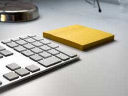 Beautiful, shiny keyboard and sticky notes on the desk