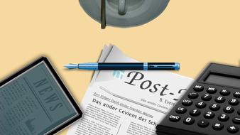 e-reader, pen and newspaper on Desk