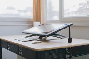 Shiny computer with the keyboard and mouse, on the wooden desk