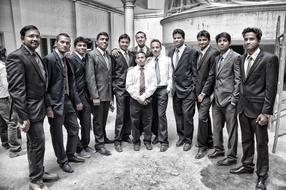 group of young asian men in tie suits outdoor