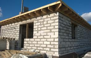 Construction of brick House with wooden roof