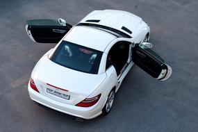 Beautiful, shiny, white Mercedes Slk car, with the open doors, outdoors