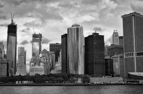 cloudy sky over skyscrapers in new york in black and white background