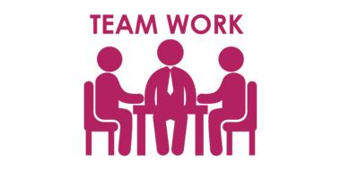 Red figures of the people, sitting at the table, and "Team Work" sign, clipart