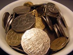 Australian coins in a white bowl