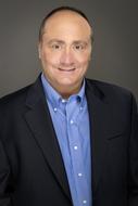 smiling man in shirt and business suit