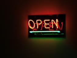 Beautiful, orange and green, neon "Open" sign of the pub in Maracaibo, Venezuela