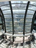 Beautiful, urban, round, glass building, among the colorful trees in Cdmx