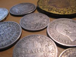 Close-up of the beautiful, shiny, silver and gold coins with the patterns