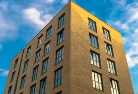 Corner of the office, with the light in the windows, in Berlin, Germany, under the blue sky with white clouds