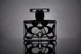 Black and white photo of the beautiful, patterned perfume bottle