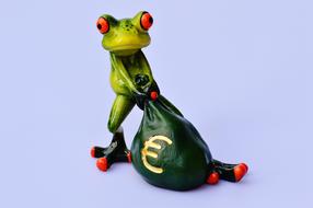 funny figurine of a frog with a bag of euro