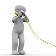silhouette of man with yellow corded telephone