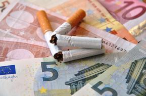 broken cigarettes on euro banknotes