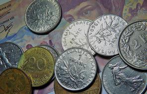 Beautiful, shiny, colorful coins, on the colorful banknotes