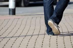 male legs walking on pavement